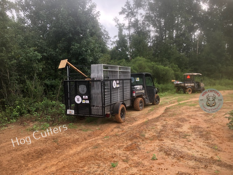 Photo of Hog Cutters moving the Jager Pro trap into a new location