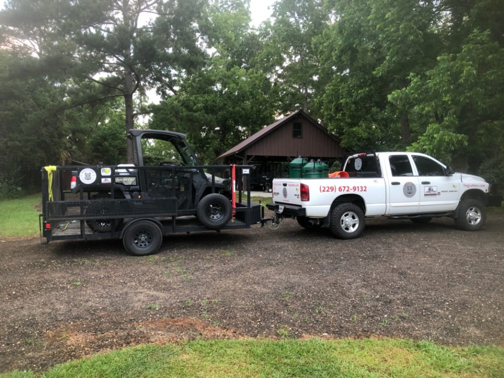 Image showing the Hog Cutters truck, John Deere Gator and Hog hauling trailer outside our Georgia Headquarters.